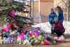 A family pays their respects at a memorial for the victims of a mass shooting in Tumbler Ridge, B.C., on Thursday, Feb. 12, 2026. THE CANADIAN PRESS/Christinne Muschi