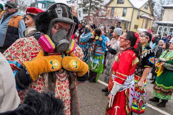 Indigenous people perform in a memorial honoring Alex Pretti and Renee Nicole Good, who were both recently fatally shot by federal agents, on Sunday in Minneapolis. (Ryan Murphy / The Associated Press)