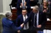 Nova Scotia Finance Minister John Lohr shakes hands with Premier Tim Houston after delivering the provincial budget at the legislature in Halifax, on Monday, Feb. 23, 2026. THE CANADIAN PRESS/Riley Smith