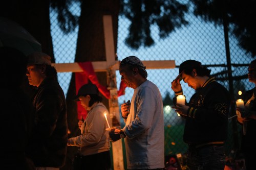 People gather for a candlelight march during a vigil on the street where a vehicle-ramming attack occurred at the Filipino community's Lapu Lapu Day festival on a provincial day of mourning for the victims in Vancouver, on Friday, May 2, 2025. THE CANADIAN PRESS/Darryl Dyck
