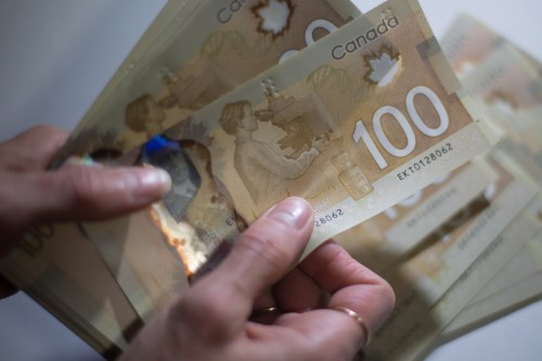 Canadian $100 bills are counted in Toronto, Feb. 2, 2016. THE CANADIAN PRESS/Graeme Roy