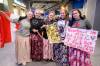 MIKE SUDOMA / FREE PRESS
                                (Left to right) Hockey players Chloe Maendel April Wollmon Tessa Walred Karlie Waldner and Alexa Maendel of Bakers Colony hold up signs and get excited for Sundays PWHL game at Canada life Centre March 22, 2026