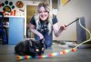 Leanne McManus plays with black cat Bowie at Tails to Tell Animal Rescue in Crossfield, Alta., on Wednesday, March 11, 2026. THE CANADIAN PRESS/Jeff McIntosh