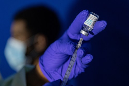 FILE - Family nurse practitioner Carol Ramsubhag-Carela prepares a syringe with the Mpox vaccine before inoculating a patient at a vaccinations site on Tuesday, Aug. 30, 2022, in the Brooklyn borough of New York. Africa's public health body said Thursday, Feb. 16, 2023 it hopes Mpox vaccines will finally arrive on the continent 