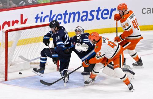 THE CANADIAN PRESS/Fred Greenslade
                                Anaheim Ducks&rsquo; Tim Washe (42) scores on Winnipeg Jets goaltender Connor Hellebuyck (37) as Haydn Fleury (24) defends during the second period of their NHL hockey game in Winnipeg, Tuesday.
