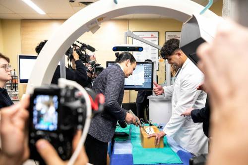 MIKAELA MACKENZIE / FREE PRESS
                                Dr. Jay Toor, orthopedic spine surgeon, shows Premier Wab Kinew how to use the new spinal surgery equipment at Concordia Hospital Friday.