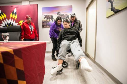 MIKAELA MACKENZIE / FREE PRESS
                                Nicholas Robinson, 16, is pushed into a press conference by his mother, Jodie Robinson, on Wednesday.