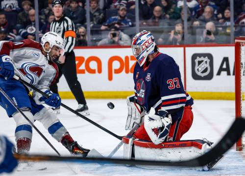 JOHN WOODS / THE CANADIAN PRESS
                                Winnipeg Jets goaltender Connor Hellebuyck (37) saves the shot from Colorado Avalanche&rsquo;s Nazem Kadri (91) during first period action in Winnipeg on Saturday.