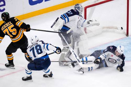 Charles Krupa / The Associated Press
                                Boston Bruins left wing Lukas Reichel (75) shoots the puck past Winnipeg Jets goaltender Connor Hellebuyck (37) for a goal during the second period of an NHL hockey game, Thursday.