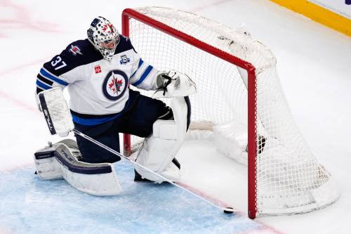 CHARLES KRUPA / THE ASSOCIATED PRESS
                                Winnipeg Jets goaltender Connor Hellebuyck slides the puck out of the net after the Boston Bruins fifth goal Thursday night.