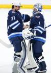 John Woods / THE CANADIAN PRESS FILES
                                Winnipeg Jets goaltender Connor Hellebuyck, left, congratulates team mate Eric Comrie on his first NHL shutout after a game 2022.