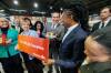 MIKE DEAL / FREE PRESS
                                On Wednesday afternoon, Premier Wab Kinew, surrounded by most of his cabinet at the Red River Co-op on Grant Avenue, prepares to take a bite out of a rotisserie chicken to celebrate removing the PST from groceries.