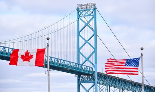 Trade talks between Canada and the U.S. are expected to be a key issue for businesses in 2026. Canadian and American flags fly near the Ambassador Bridge at the Canada/USA border crossing in Windsor, Ont. on Saturday, March 21, 2020. THE CANADIAN PRESS/Rob Gurdebeke