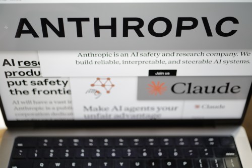 Pages from the Anthropic website and the company's logos are displayed on a computer screen in New York on Thursday, Feb. 26, 2026. (AP Photo/Patrick Sison)