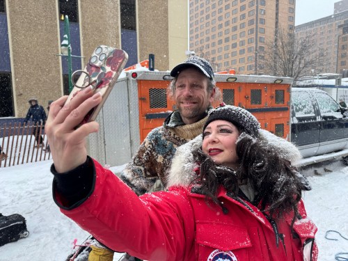 Defending Iditarod Trail Sled Dog Race champion Jessie Holmes poses for a selfie with a fan during the ceremonial start of this year's race in downtown Anchorage, Alaska, on Saturday, March 7, 2026. (AP Photo/Mark Thiessen)