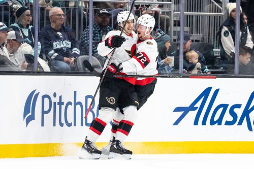 Ottawa Senators forward Dylan Cozens, left, and defenseman Thomas Chabot celebrate a goal during the first period of an NHL hockey game against the Seattle Kraken Saturday, March 7, 2026, in Seattle. (AP Photo/Stephen Brashear)