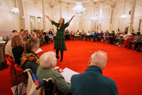 People, many of them seniors with a form of dementia, join in the 
