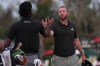 Daniel Berger, right, greets Akshay Bhatia on the 16th hole during the third round of the Arnold Palmer Invitational at Bay Hill golf tournament Saturday, March 7, 2026, in Orlando, Fla. (AP Photo/Matt Slocum)