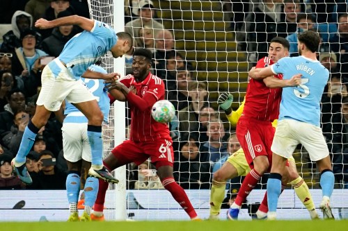 Manchester City's Rodri, left, scores his side's second goal during the English Premier League soccer match between Manchester City and Nottingham Forest in Manchester, England, Wednesday, March 4, 2026. (AP Photo/Dave Thompson)