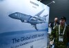 Attendees pass an image of the Bombardier Global 6500 Aircraft at the CANSEC trade show in Ottawa on Wednesday, May 31, 2023. THE CANADIAN PRESS/Justin Tang