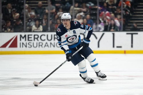 Winnipeg Jets centre Mark Scheifele skates with the puck in an NHL game against the Anaheim Ducks on Feb. 27, 2026, in Anaheim, Calif. (AP Photo/Kyusung Gong)