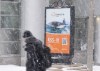A man walks past an ad for military submarines in the downtown core near Parliament Hill in Ottawa on Thursday, Jan. 15, 2026. THE CANADIAN PRESS/Adrian Wyld