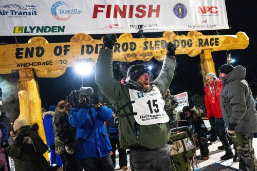FILE - Jessie Holmes celebrates after winning the Iditarod Trail Sled Dog Race, March 14, 2025, in Nome, Alaska. (Loren Holmes/Anchorage Daily News via AP, File)