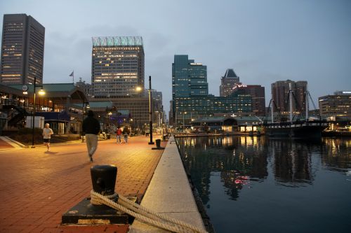 People walk around Baltimore's Inner Harbor on March 5, 2026. (AP Photo/Michael Phillis)