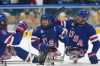United States' Josh Pauls, center, celebrates with his teammates after scoring during the Group A ice hockey match between United States and China at the 2026 Winter Paralympics, in Milan, Italy, Tuesday, March 10, 2026. (AP Photo/Antonio Calanni)