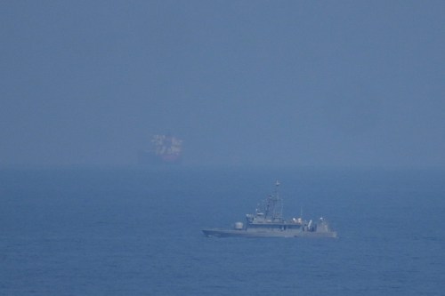 A UAE navy ship patrols the Strait of Hormuz as seen from Mina Al Fajer, United Arab Emirates, Wednesday, March 11, 2026. (AP Photo/Altaf Qadri)