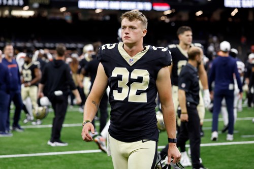 FILE - New Orleans Saints punter Kai Kroeger (32) walks off the field after an NFL preseason football game against the Denver Broncos, Aug. 23, 2025, in New Orleans. (AP Photo/Tyler Kaufman, File)
