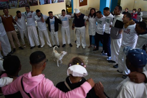 People undergoing rehabilitation hug in a circle at a psychiatric hospital in Havana, Cuba, Wednesday, Feb. 25, 2026. (AP Photo/Ramon Espinosa)