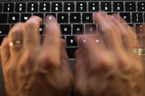 A man uses a computer keyboard in Toronto in this October 9, 2023, photo illustration. THE CANADIAN PRESS/Graeme Roy