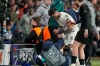 Chelsea's Enzo Fernandez helps a ballboy to his feet after teammate Pedro Neto pushed him over in a rush to get the ball back in play, during the first leg of the Champions League round of 16 soccer match between Paris Saint-Germain and Chelsea, in Paris, Wednesday, March 11, 2026. (AP Photo/Michel Euler)