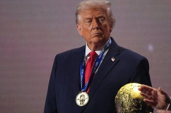 FILE - President Donald Trump stands on stage next to the FIFA World Cup after receiving the FIFA Peace Prize during the draw for the 2026 soccer World Cup at the Kennedy Center in Washington, Dec. 5, 2025. (AP Photo/Jacquelyn Martin, File)
