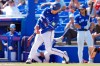 Toronto Blue Jays' Daulton Varsho hits a run-scoring fielder's choice against Canada pitcher Noah Skirrow during the second inning of an exhibition baseball game Tuesday, March 3, 2026, in Dunedin, Fla. (AP Photo/Chris O'Meara)