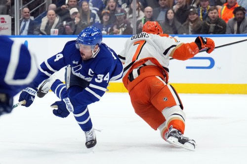 Maple Leafs captain Auston Matthews (34) is injured by a knee-on-knee hit by Anaheim Ducks defenceman Radko Gudas (7) in Toronto on Thursday, March 12, 2026. THE CANADIAN PRESS/Nathan Denette