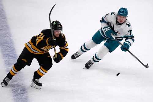 San Jose Sharks center Macklin Celebrini, right, and Boston Bruins left wing Viktor Arvidsson skate after the puck during the first period of an NHL hockey game, Thursday, March 12, 2026, in Boston. (AP Photo/Charles Krupa)