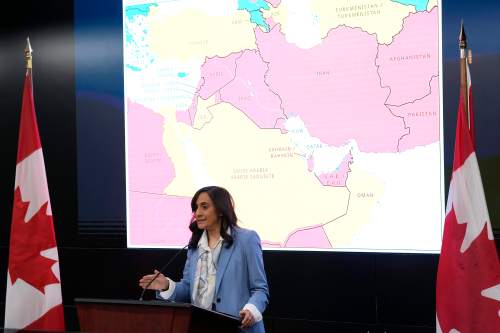 A map showing travel advisory risk levels in the Middle East is shown as Minister of Foreign Affairs Anita Anand speaks at a news conference at the Emergency Watch and Response Centre at Global Affairs Canada in Ottawa, on Wednesday, March 4, 2026. THE CANADIAN PRESS/Justin Tang