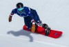 Noah Elliott of the US competing in the Para Snowboard Men's Banked Slalom SB-LL Run 1 at the 2026 Winter Paralympics, in Cortina d'Ampezzo, Italy, Friday March 13, 2026. (AP Photo/Kirsty Wigglesworth)