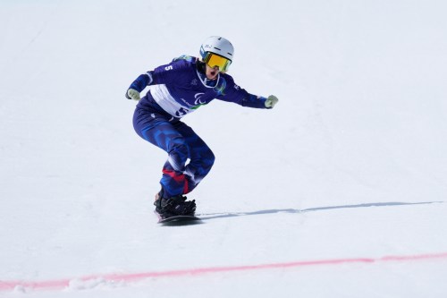 Cecile Hernandez, of France, approaches the finish line in her second run of the snowboard women's banked slalom sb-ll2 at the 2026 Winter Paralympics, in Cortina d'Ampezzo, Italy, Friday, March 13, 2026. (AP Photo/Evgeniy Maloletka)