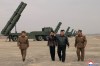 In this photo provided by the North Korean government, its leader Kim Jong Un, center right, and his daughter, center left, attend a live-fire test of multiple rocket launch systems, at an undisclosed place in North Korea Saturday, March 14, 2026. Independent journalists were not given access to cover the event depicted in this image distributed by the North Korean government. The content of this image is as provided and cannot be independently verified. Korean language watermark on image as provided by source reads: 