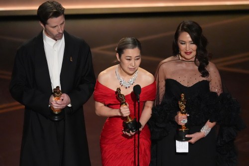 Chris Appelhans, from left, Maggie Kang, and Michelle L.M. Wong accept the award for animated feature film for 