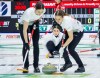 Switzerland skip Xenia Schwaller, centre, makes a shot against Japan as lead Selina Rychiger, left, and third Selina Gafner sweep at the World Women's Curling Championship in Calgary, Saturday, March 14, 2026.  THE CANADIAN PRESS/Jeff McIntosh