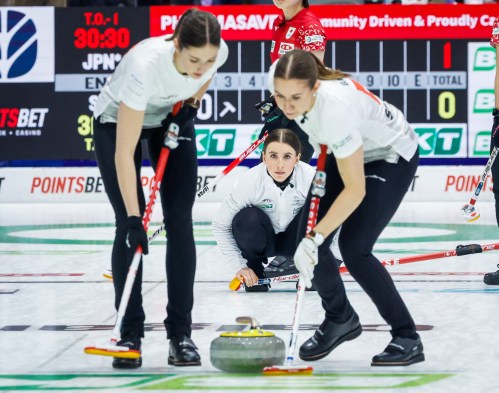 Switzerland skip Xenia Schwaller, centre, makes a shot against Japan as lead Selina Rychiger, left, and third Selina Gafner sweep at the World Women's Curling Championship in Calgary, Saturday, March 14, 2026.  THE CANADIAN PRESS/Jeff McIntosh