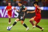 Australia's Sam Kerr passes the ball as China's Zhang Chengxue, right, watches during the Women's Asian Cup semifinal soccer match between China and Australia in Perth, Australia, Tuesday, March 17, 2026. (AP Photo/Gary Day)
