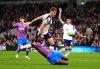 Tottenham Hotspur's Micky van de Ven,top, fouls Crystal Palace's Ismaila Sarr resulting in a red card and a penalty kick during the English Premier League soccer match between Tottenham Hotspur and Crystal Palace in London, Thursday March 5, 2026. (John Walton/PA via AP)
