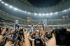 FILE - Argentina's Lionel Messi celebrates with the trophy in front of fans after winning the World Cup final soccer match between Argentina and France in Lusail, Qatar, Dec. 18, 2022. (AP Photo/Martin Meissner, File)