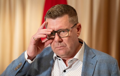 Saskatchewan Premier Scott Moe adjusts hs glasses as he speaks with reporters in Mumbai, India, Friday, Feb. 27, 2026. THE CANADIAN PRESS/Adrian Wyld