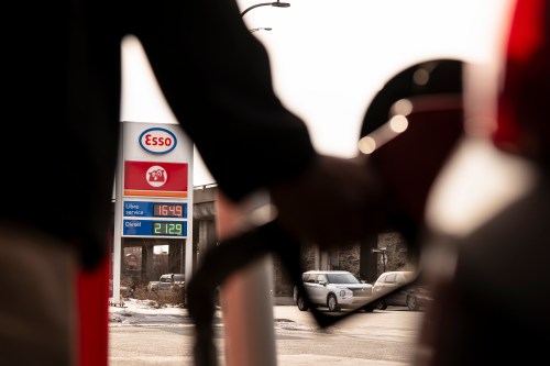 Fuel prices are displayed as a person fills up their car with gas at a station in Montreal on Thursday, March 5, 2026. THE CANADIAN PRESS/Christopher Katsarov